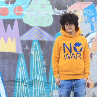 Handbedruckter Hoodie in gelb mit der Aufschrift NO WAR in blau vor einer Grafiti Wand